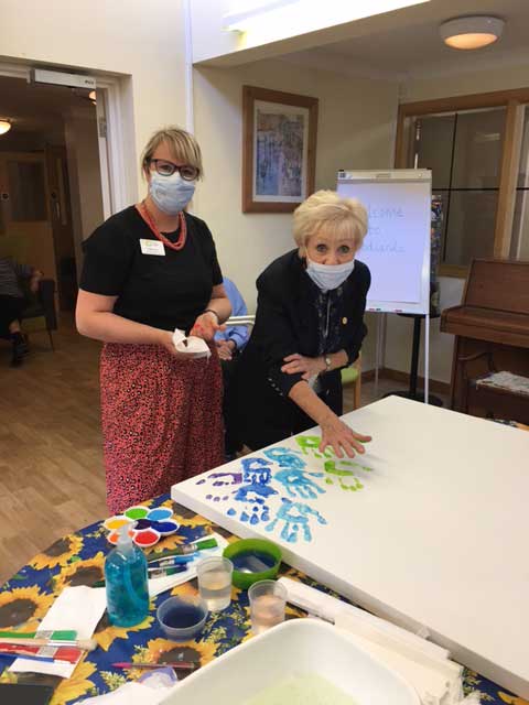 Hand prints picture, community masterpiece being painted.