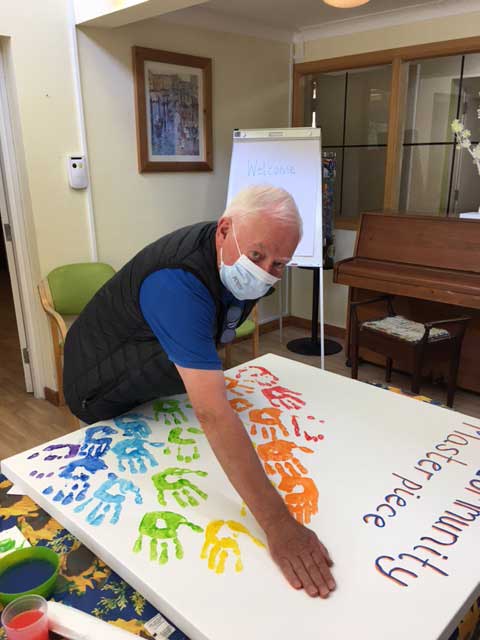 Hand prints picture, community masterpiece being painted.